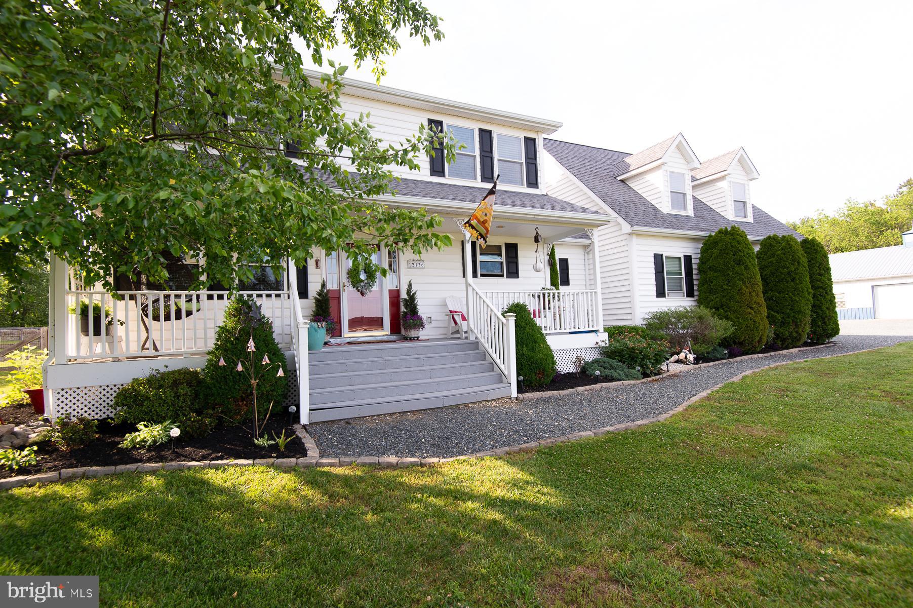 12136 Holly Road Ridgely, MD 21660 - Photo 108 of 136 a front view of a house with a garden and plants