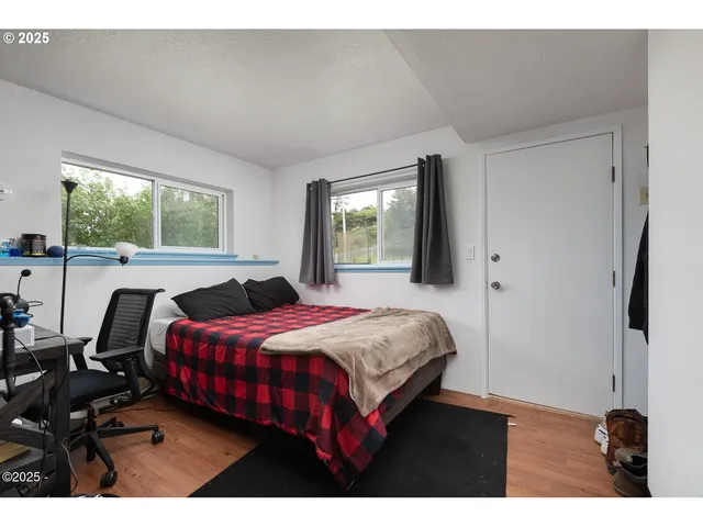 a bedroom with a bed and a large window