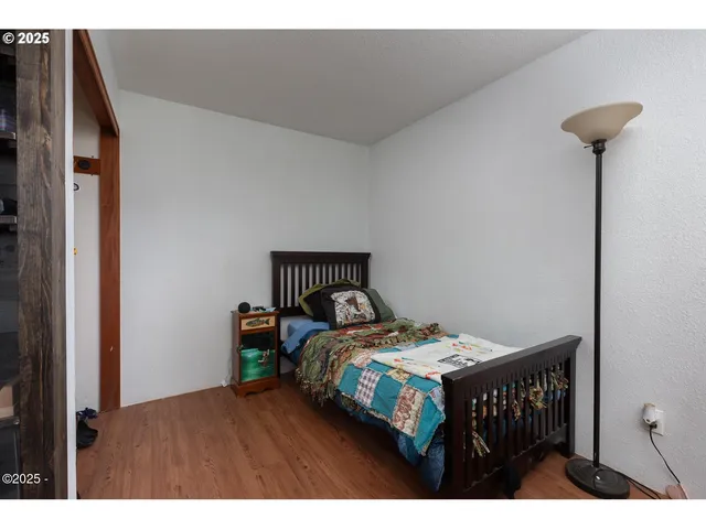 a bedroom with a bed and a night stand