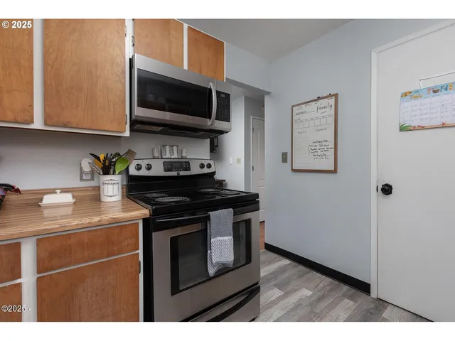 a kitchen with stainless steel appliances granite countertop a stove and a microwave