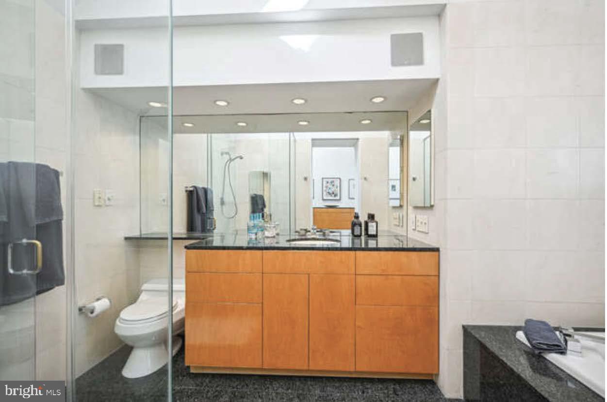 4527 Q Place Northwest Washington, DC 20007 - Photo 15 of 24 a bathroom with a toilet sink and mirror