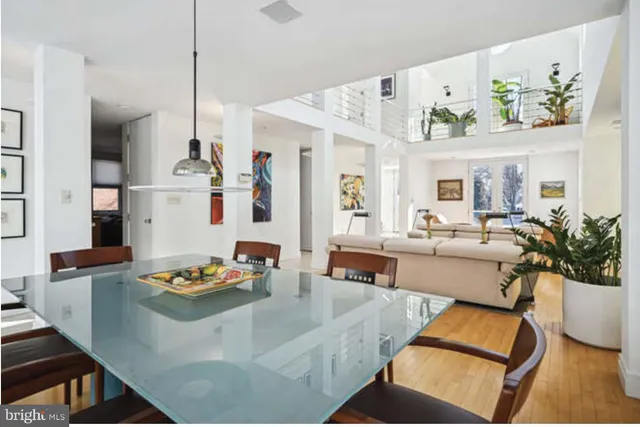 a living room with furniture fireplace and a large window