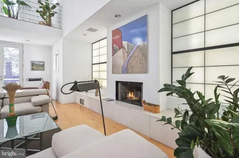a view of a hallway with wooden floor and windows