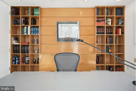 a dining table with chairs and window