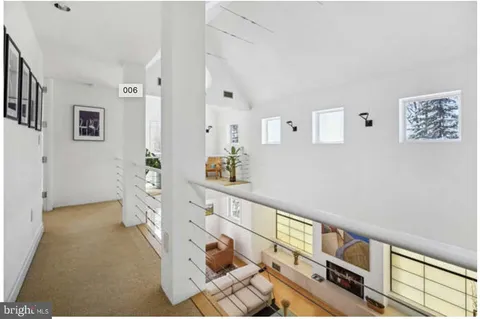 a spacious bedroom with a bed and chair