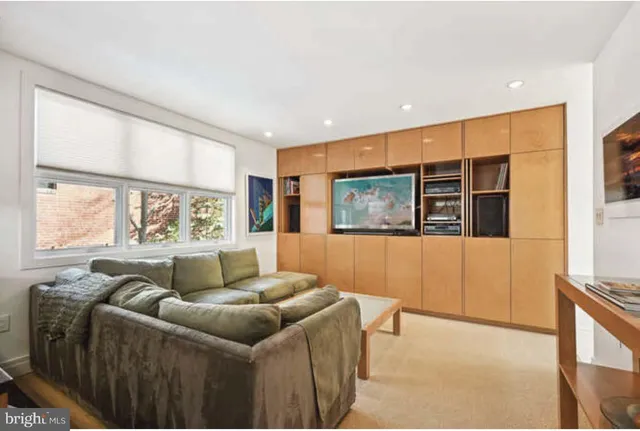 a view of living room with furniture and a fireplace