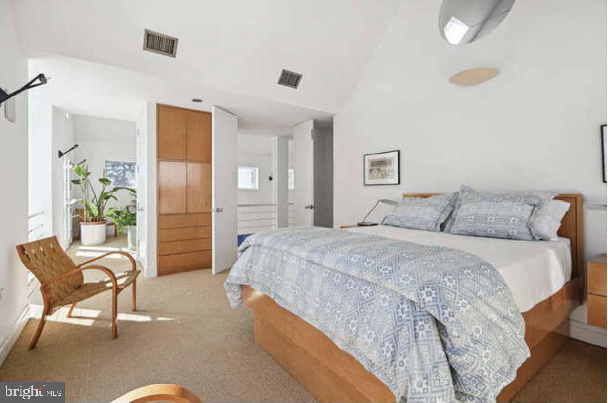 4527 Q Place Northwest Washington, DC 20007 - Photo 34 of 54 a spacious bedroom with a bed and chair