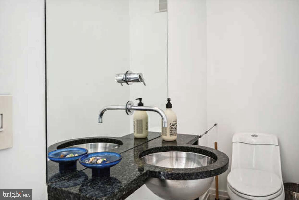 4527 Q Place Northwest Washington, DC 20007 - Photo 52 of 54 a bathroom with a granite countertop toilet and a sink