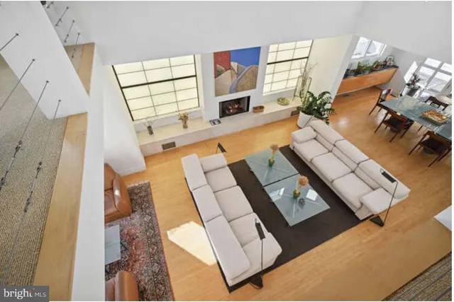 a living room with kitchen island granite countertop furniture and a fireplace