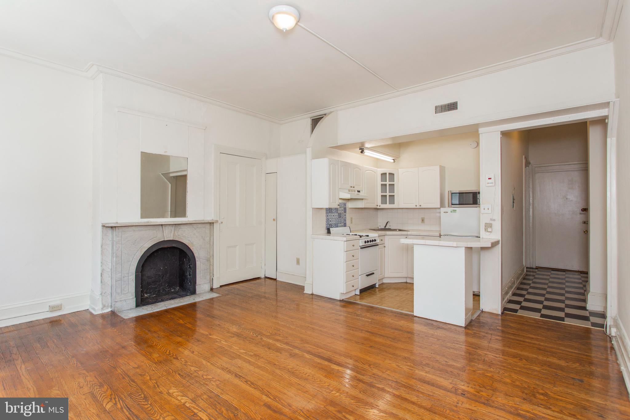 1807 Spruce Street, Unit 2F Philadelphia, PA 19103 - Photo 1 of 17 a kitchen with a refrigerator and white cabinets
