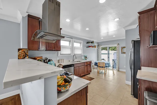 a kitchen with a stove a refrigerator and a dining table