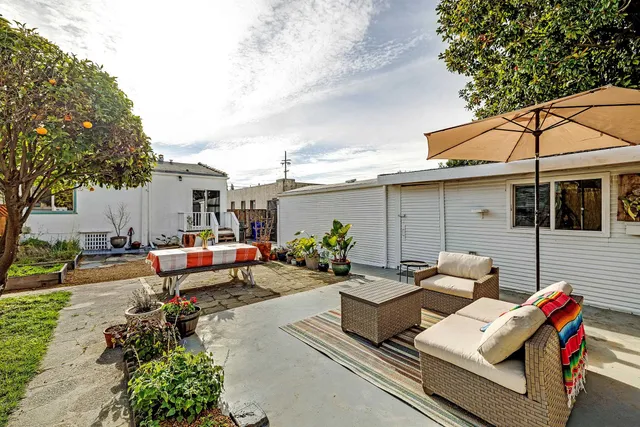 a view of a backyard with a small cabin