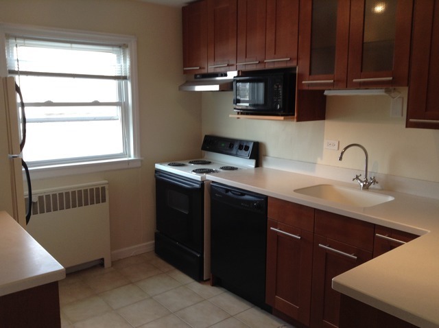 7522 North Ridge Boulevard, Unit 3E Chicago, IL 60645 - Photo 3 of 7 a kitchen with stainless steel appliances a stove a sink and a microwave