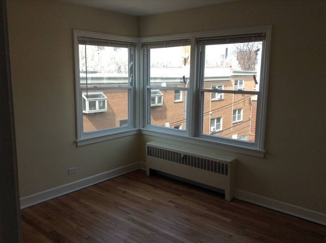 7522 North Ridge Boulevard, Unit 3E Chicago, IL 60645 - Photo 4 of 7 a room with window and wooden floor