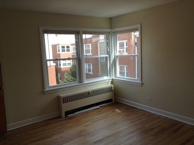 7522 North Ridge Boulevard, Unit 3E Chicago, IL 60645 - Photo 5 of 7 a view of an empty room with wooden floor and a window