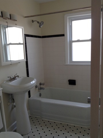 7522 North Ridge Boulevard, Unit 3E Chicago, IL 60645 - Photo 6 of 7 a bathroom with a sink a bathtub and next to a window