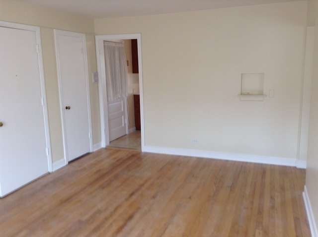 7522 North Ridge Boulevard, Unit 3E Chicago, IL 60645 - Photo 7 of 7 a view of an empty room with wooden floor