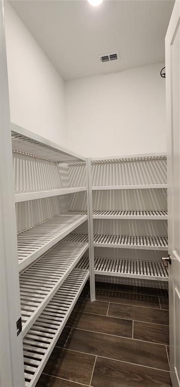 29868 Picana Lane Wesley Chapel, FL 33543 - Photo 12 of 75 a view of a room with racks on the wall