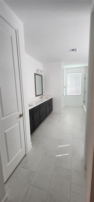 29868 Picana Lane Wesley Chapel, FL 33543 - Photo 18 of 75 a view of a hallway to rooms and stairs