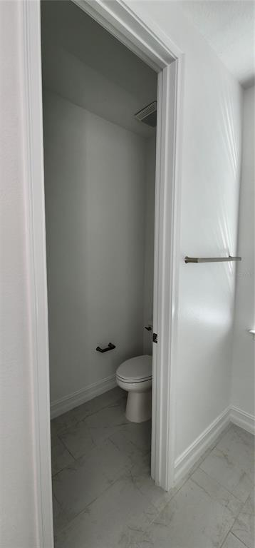 29868 Picana Lane Wesley Chapel, FL 33543 - Photo 21 of 75 a bathroom with a granite countertop toilet and a sink