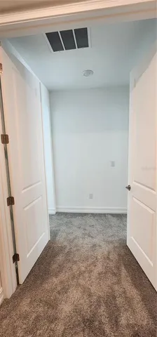 an empty room with a empty space and windows