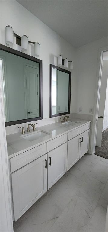29868 Picana Lane Wesley Chapel, FL 33543 - Photo 31 of 75 a bathroom with a double vanity sink and mirror