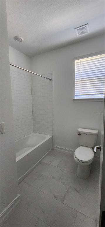 29868 Picana Lane Wesley Chapel, FL 33543 - Photo 33 of 75 a bathroom with a toilet a sink and bathtub