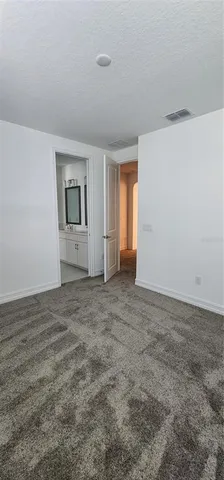 a view of a field with a tree in the background