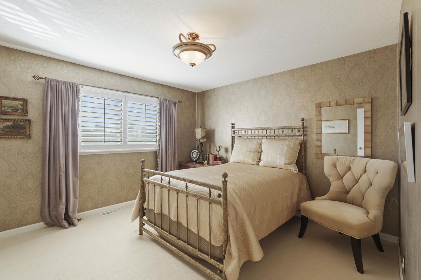 1636 Timberlake Circle Lodi, CA 95242 - Photo 20 of 44 a bedroom with a bed and a chandelier