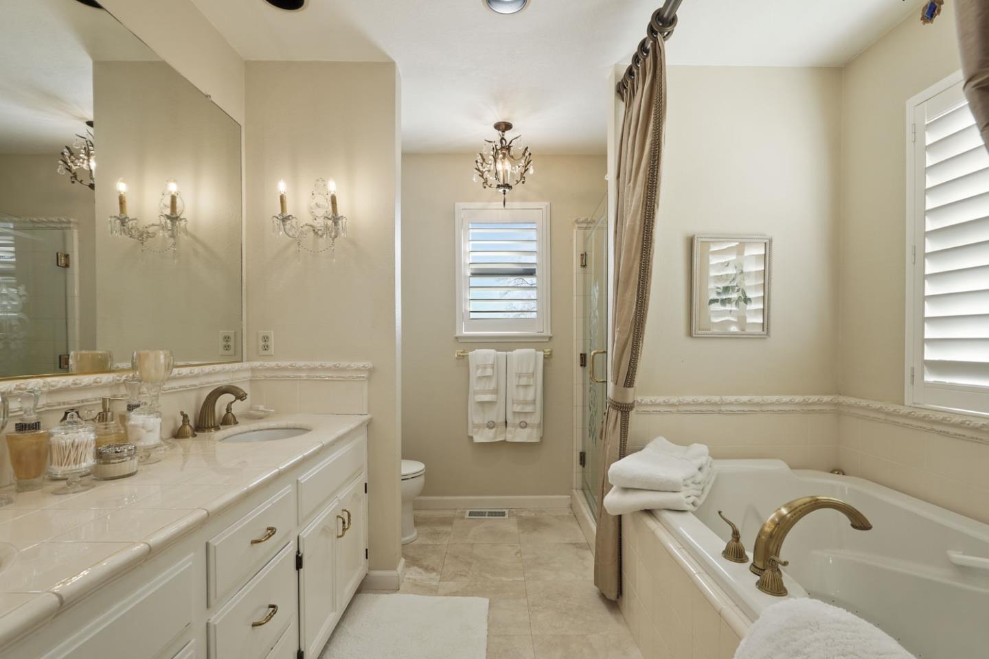 1636 Timberlake Circle Lodi, CA 95242 - Photo 28 of 44 a bathroom with a tub sink and mirror