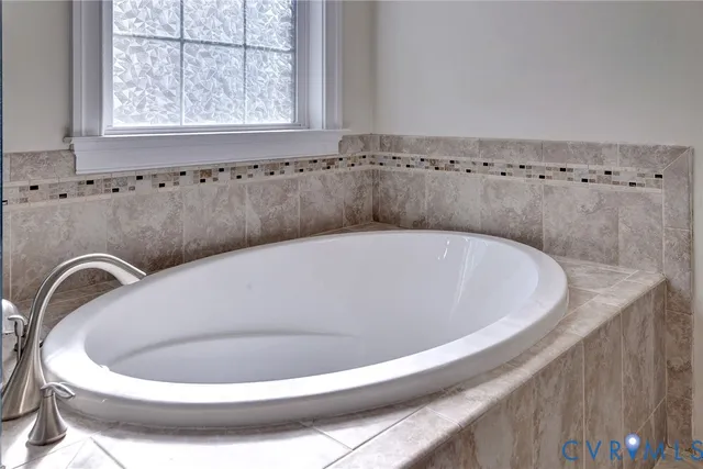 a white bath tub sitting in a bathroom