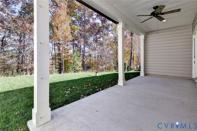 a view of a porch with furniture and garden