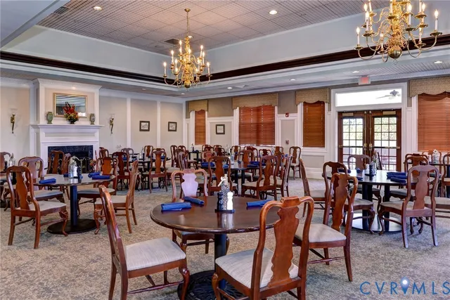 a view of a dining room with furniture and chandelier