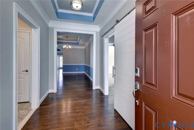 a view of a hallway with wooden floor and closet