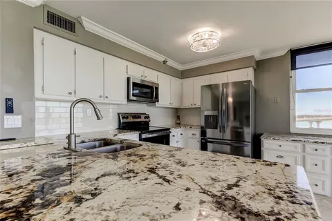 a kitchen with a refrigerator stove and a sink