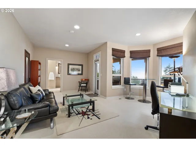 a living room with furniture and a dining table with wooden floor