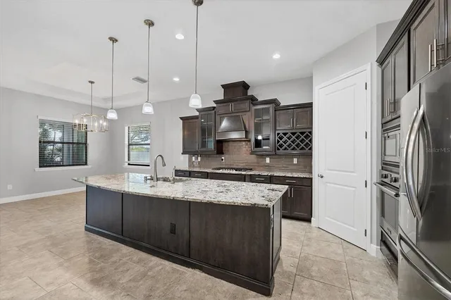 a view of a dining room with furniture and chandelier