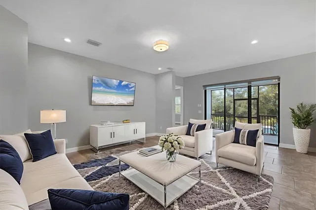 a kitchen with granite countertop kitchen island stainless steel appliances a sink stove and a center island