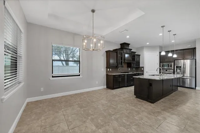 a kitchen with stainless steel appliances granite countertop a stove and a sink