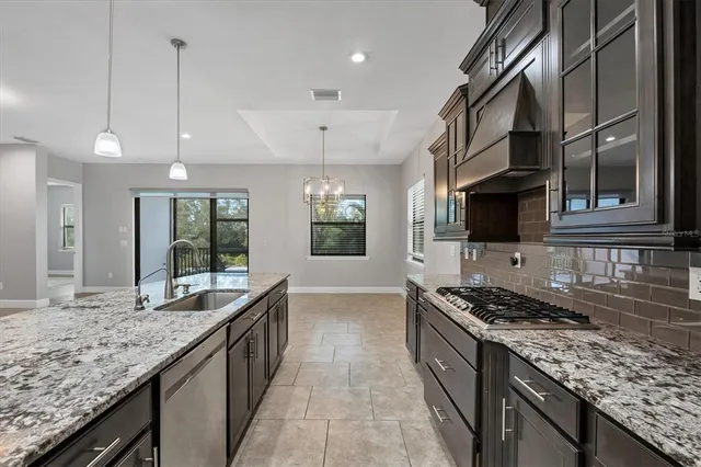 a view of a dining room with furniture and a kitchen