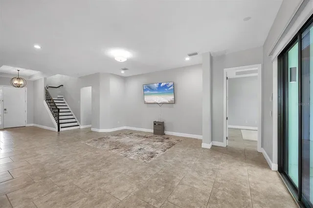 a bedroom with bed tv and window