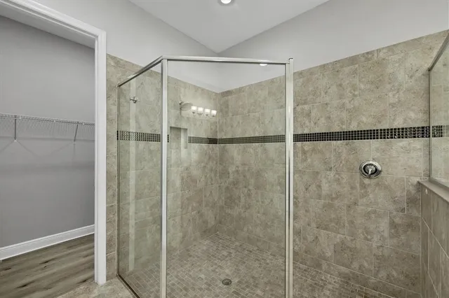 a bathroom with a granite countertop sink toilet and mirror