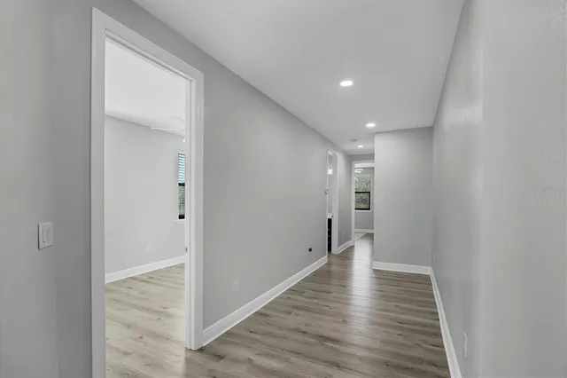 a view of hallway with wooden floor