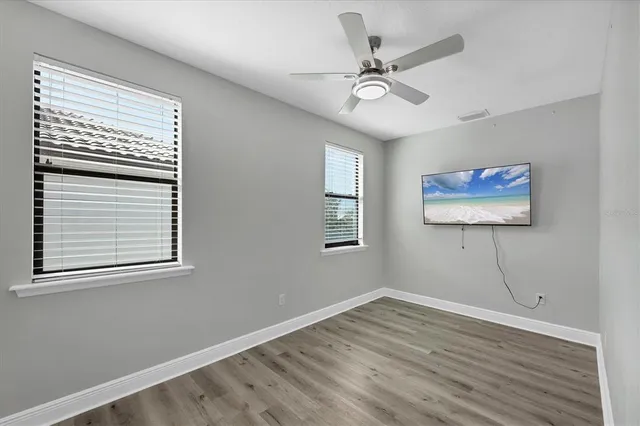 wooden floor in an empty room with a window