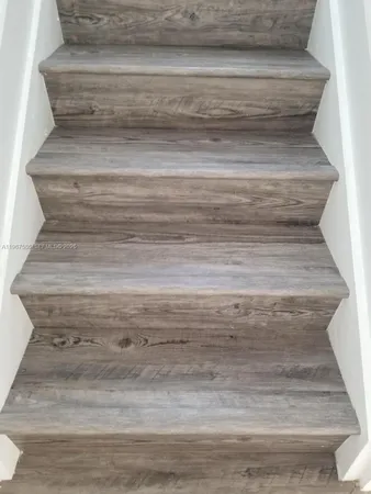 a view of a room with wooden floor and window