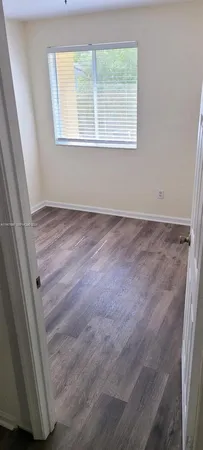 a view of a kitchen with white cabinets