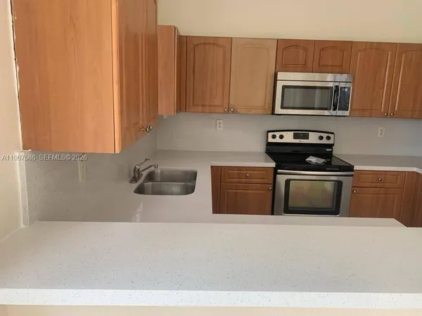 a view of kitchen with kitchen island counter top space