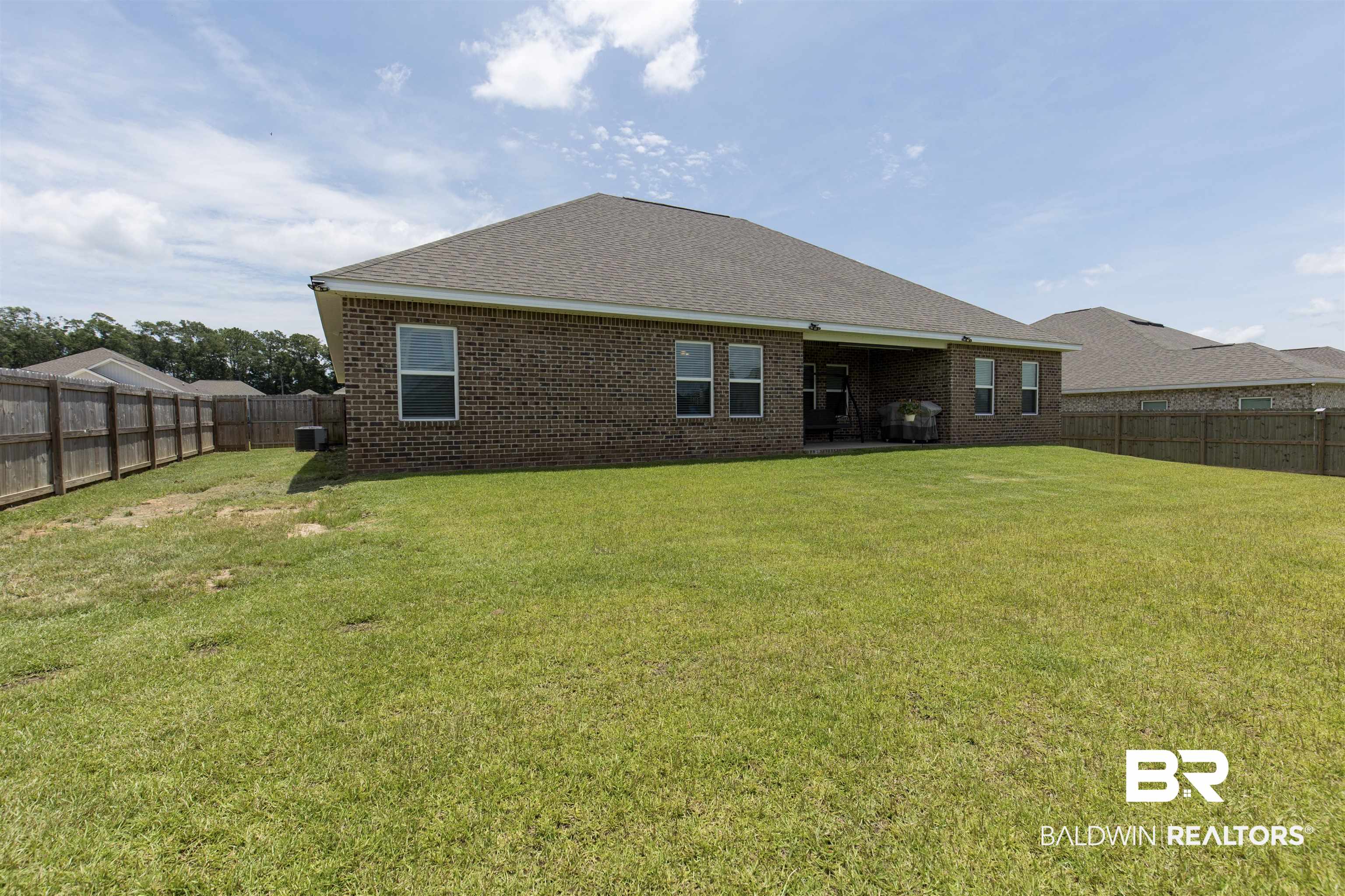 2345 Laurel Street Semmes, AL 36575 - Photo 25 of 31 Rear view of house with a fenced backyard, brick siding, and a shingled roof