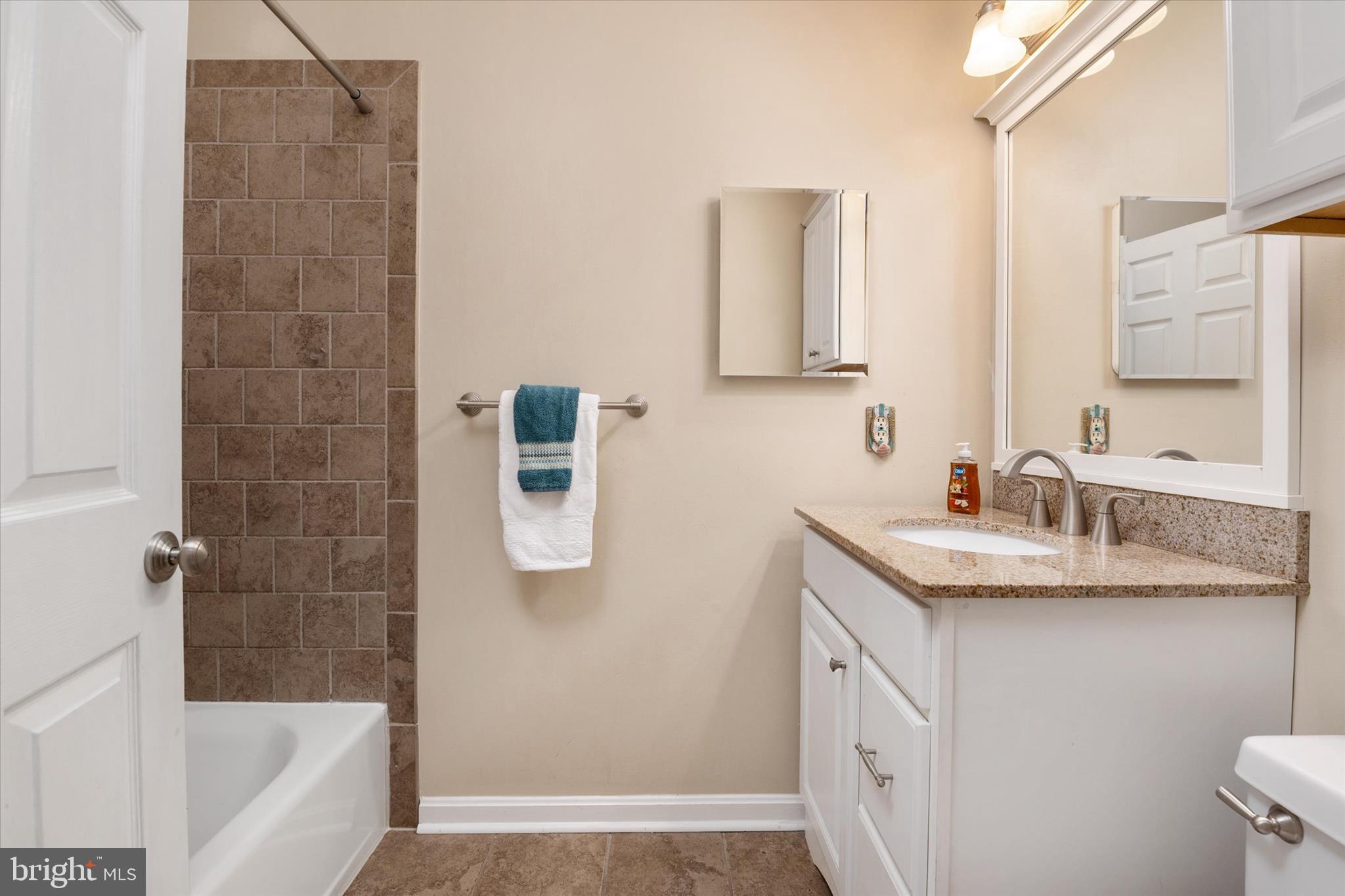 2008 Bridgepointe Drive Chester, MD 21619 - Photo 22 of 41 a bathroom with a granite countertop sink a mirror and a bathtub