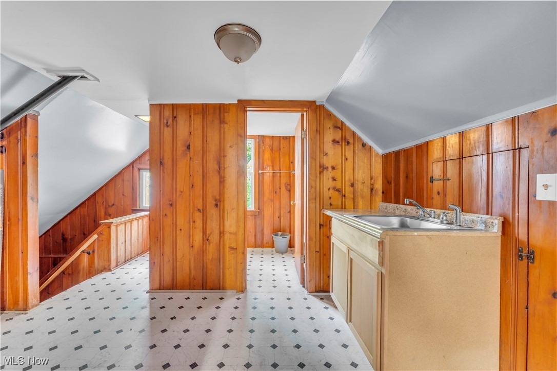 913 Helmsdale Road, Unit 3 Cleveland, OH 44112 - Photo 10 of 19 Laundry area with light floors and wood walls